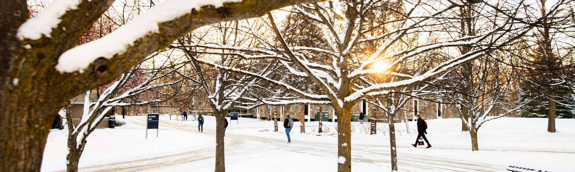 Students walking on campus in the snow on the way to class
